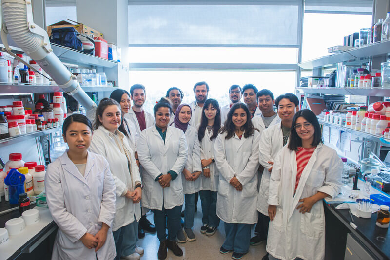 a group of students and faculty in a lab